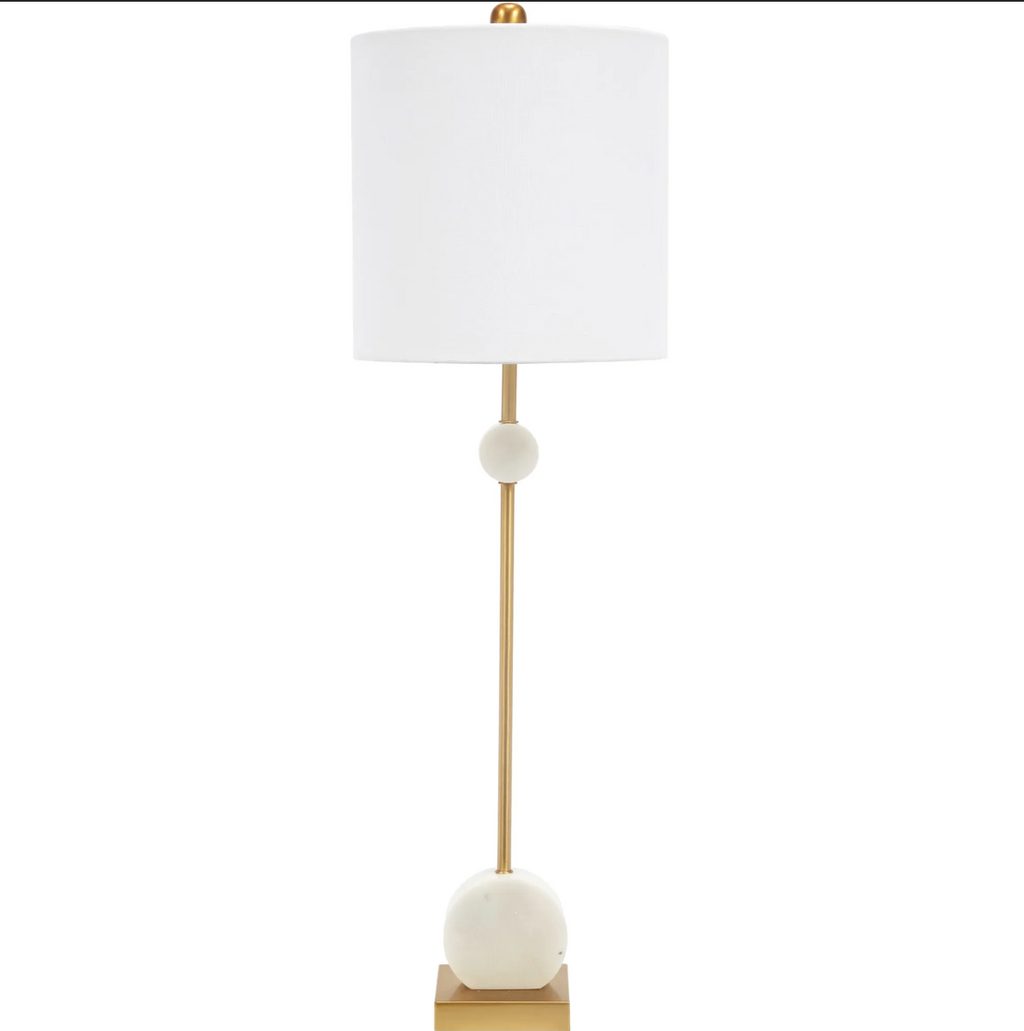 Slender gold table lamp with white alabaster accents and a white drum lampshade