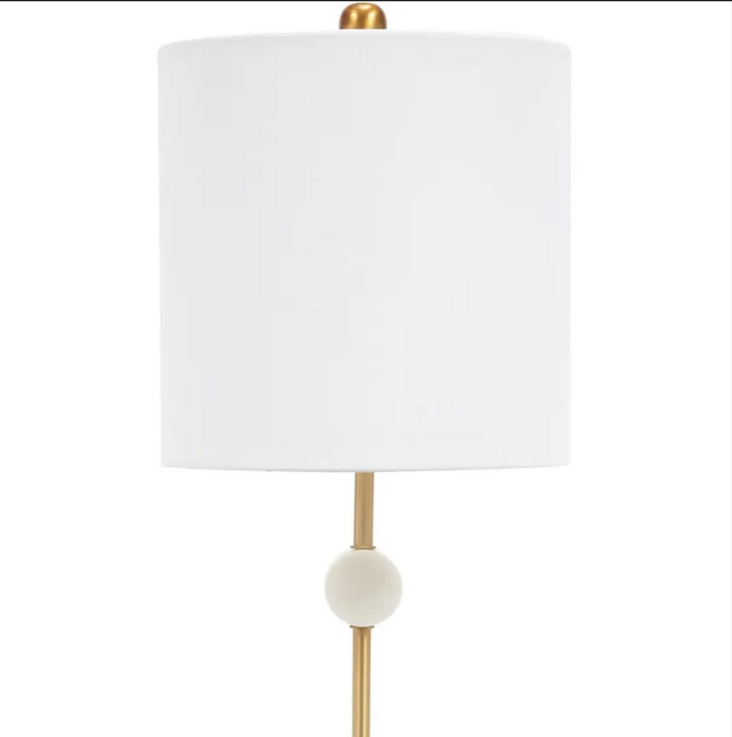 Slender gold table lamp with white alabaster accents and a white drum lampshade