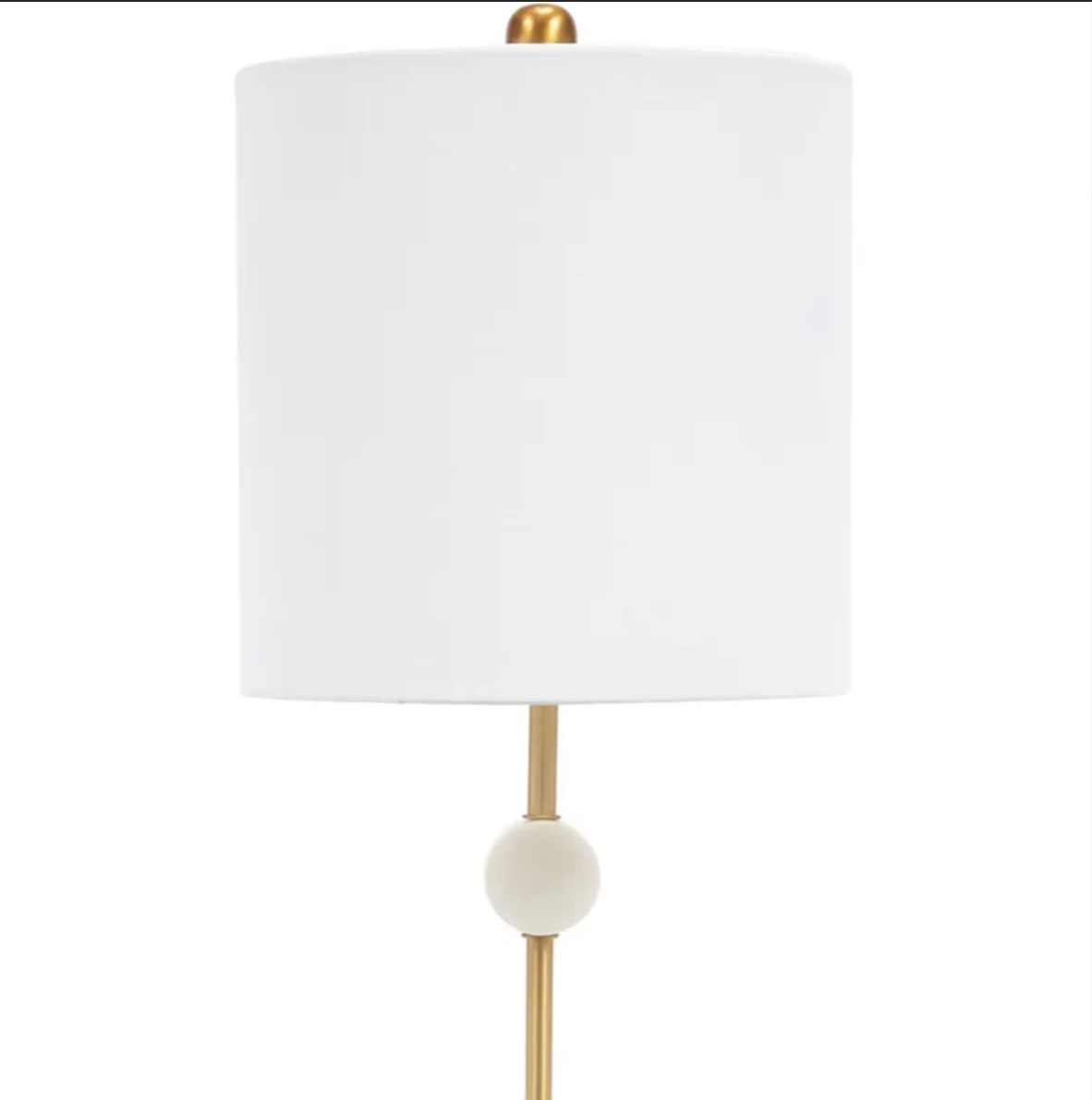 Slender gold table lamp with white alabaster accents and a white drum lampshade
