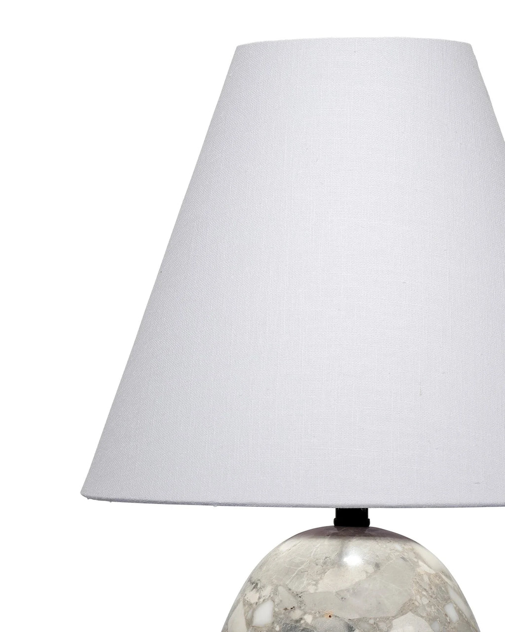 Grey travertine stone table lamp with a sculptural shape and white tapered lampshade
