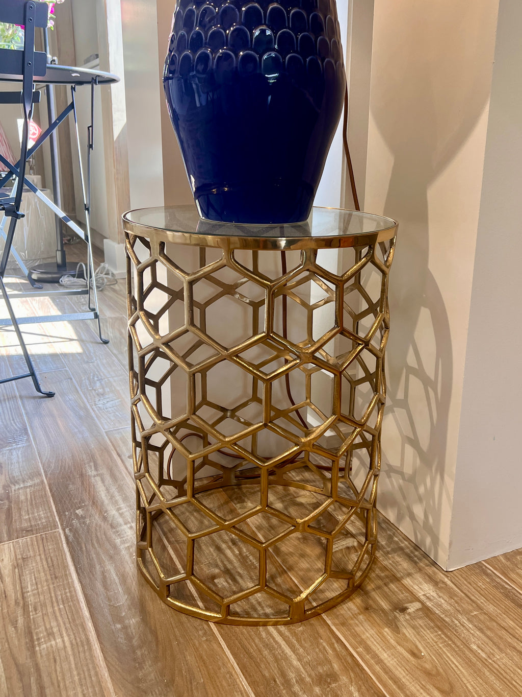 Contemporary brass and glass accent table with geometric honeycomb pattern, styled in Nashville, Tennessee