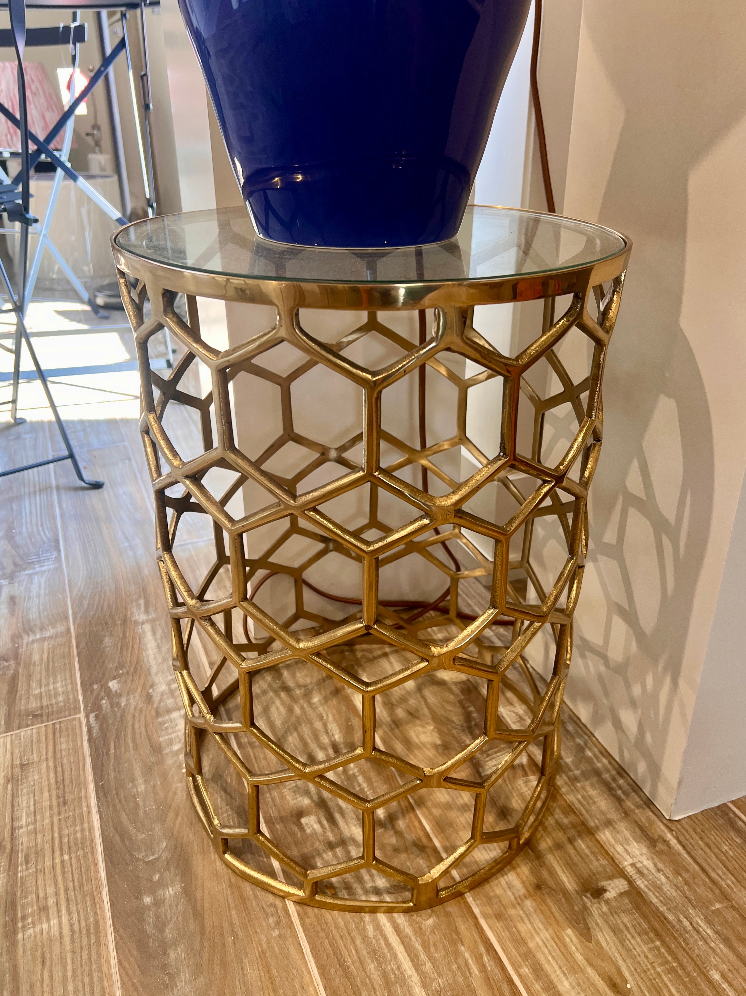 Contemporary brass and glass accent table with geometric honeycomb pattern, styled in Nashville, Tennessee