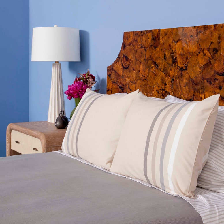 Aurelia white concrete table lamp with scallop detail and gold leaf accents. Styled in a bedroom in Nashville, Tennessee