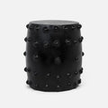 A black cylindrical garden stool with a matte finish and raised circular studs around the sides.