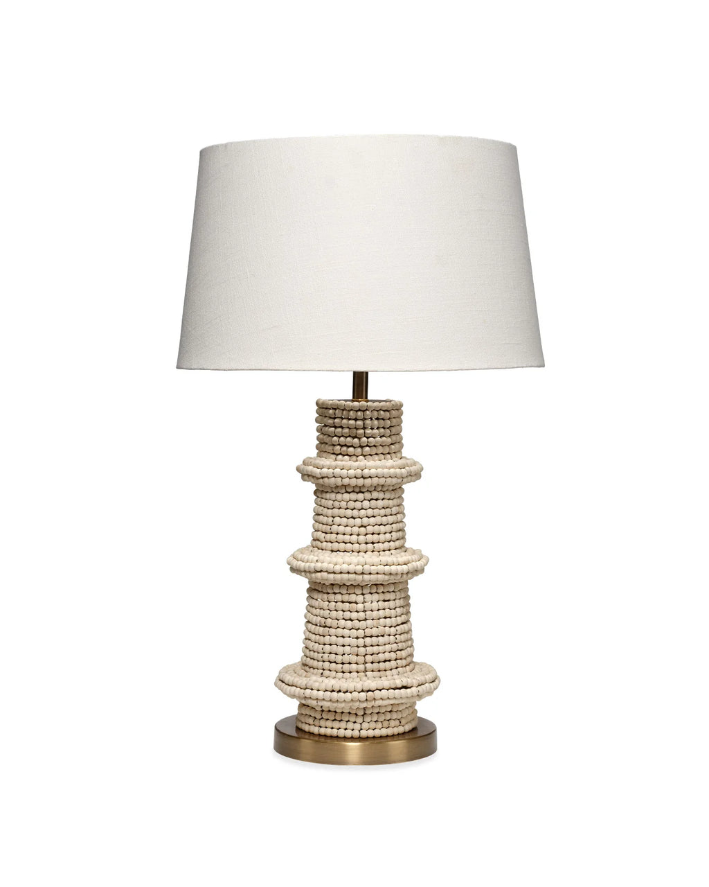Artisanal table lamp made from hand carved mango beads with a dark brass base and white linen lampshade.