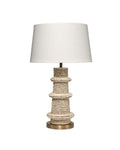 Artisanal table lamp made from hand carved mango beads with a dark brass base and white linen lampshade.