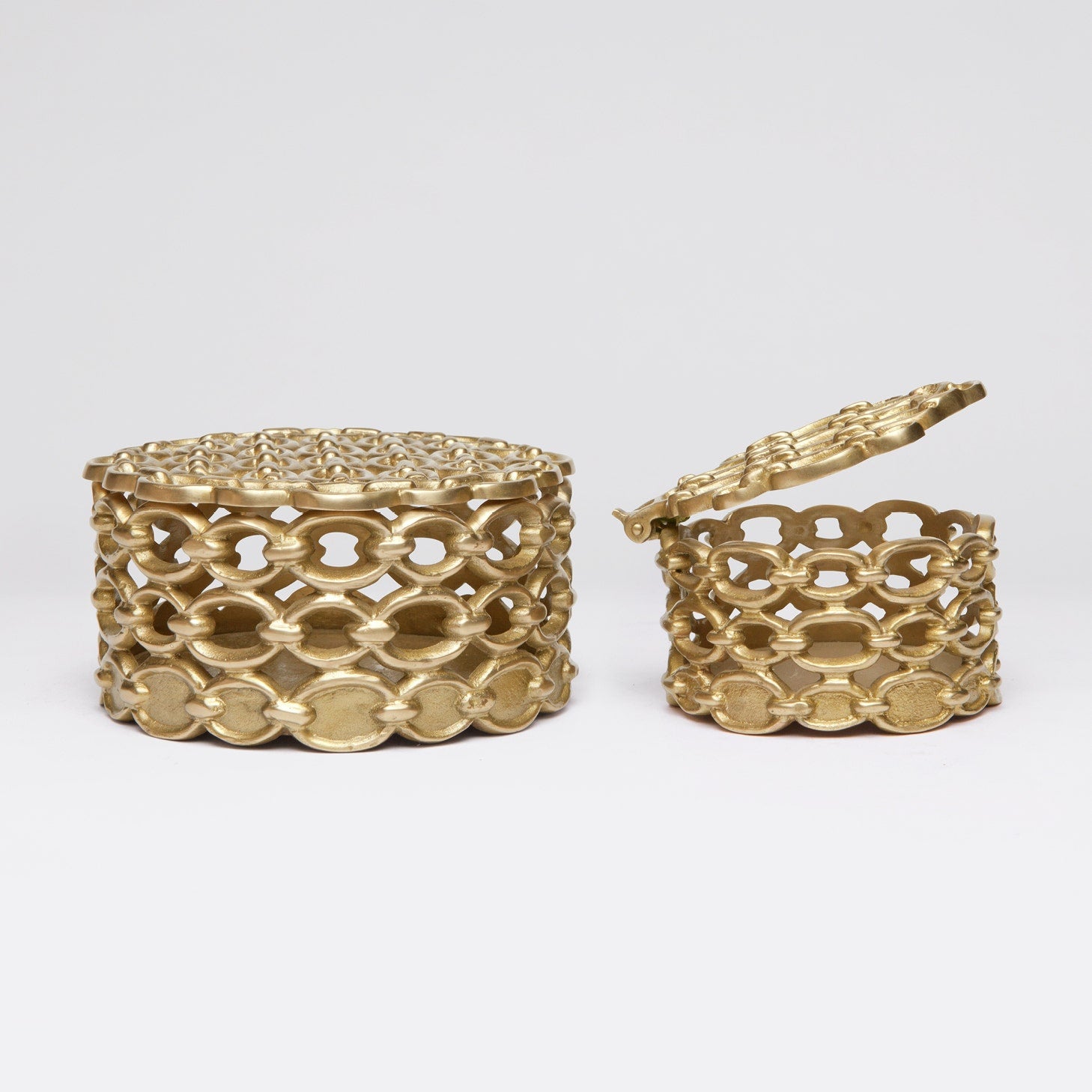 Set of decorative lidded brass boxes with a chain motif