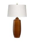 Table lamp with a brown ceramic base and white shade on a white background