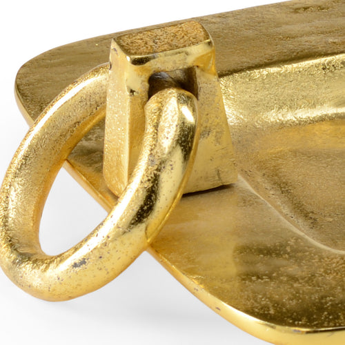 Cleo Gold Tray featuring an elongated rectangular silhouette, textured antique gold finish, raised edges, and sculptural ring handles at each end, displayed on a white background.
