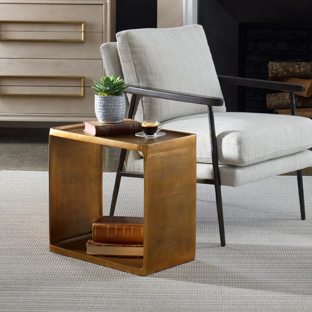 Emerson Side Table in antique brass finish, featuring a modern rectangular open-frame design with a smooth top and lower shelf.