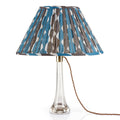 Fermoie Blue and Neutral Whittle oval lampshade styled on a glass table lamp in Nashville, Tennessee