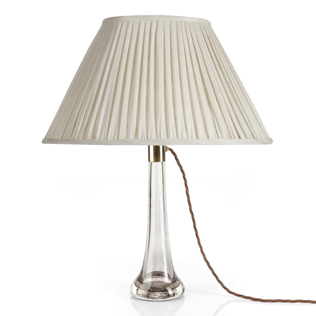Fermoie Cream Moire oval lampshade styled on a glass table lamp in Nashville, Tennessee