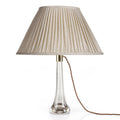 Fermoie Ecru Figured Oval lampshade styled on a glass table lamp in Nashville, Tennessee