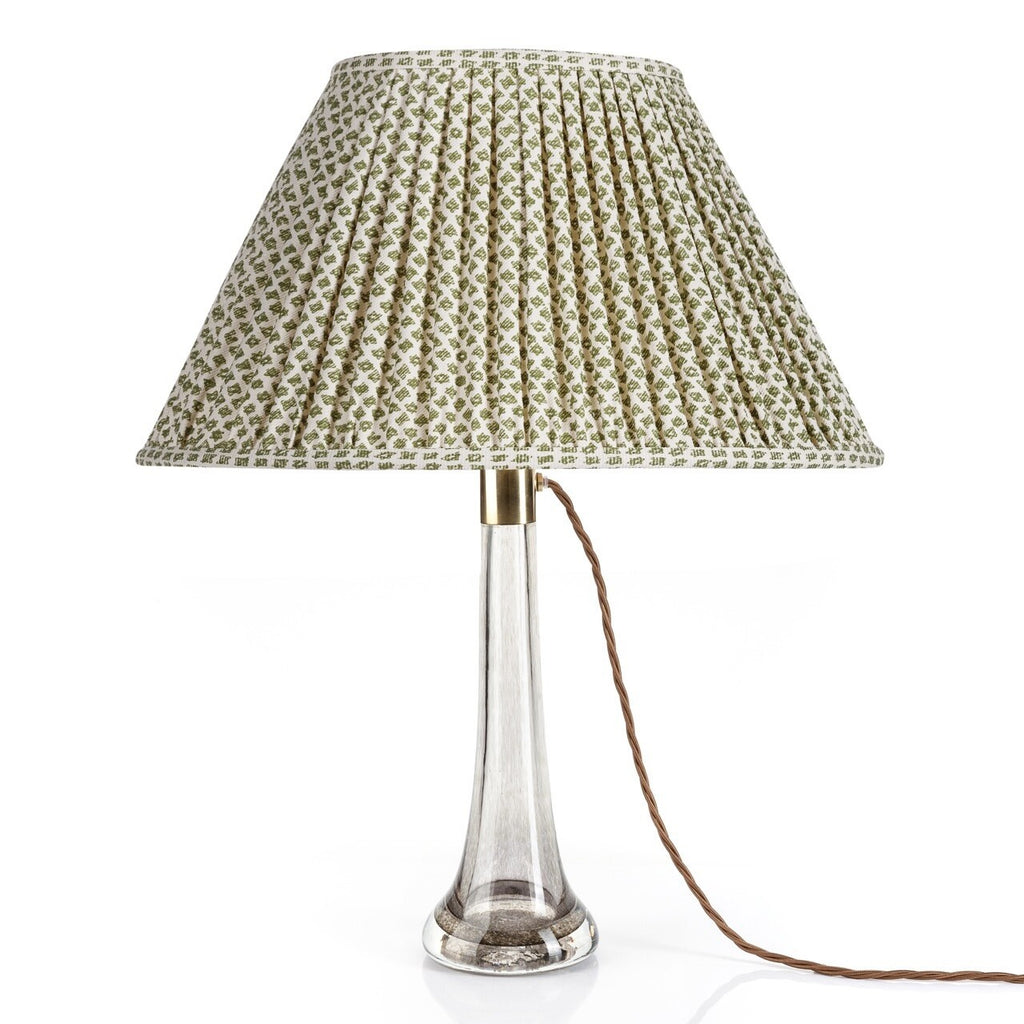 Fermoie Green Marden Oval lampshade styled on a glass table lamp