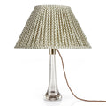 Fermoie Green Marden Oval lampshade styled on a glass table lamp