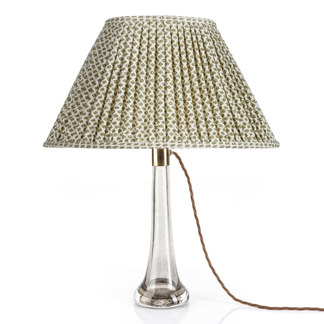 Fermoie Green Marden Oval lampshade styled on a glass table lamp