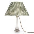 Fermoie Green Wicker oval lampshade styled on a glass table lamp in Nashville, Tennessee