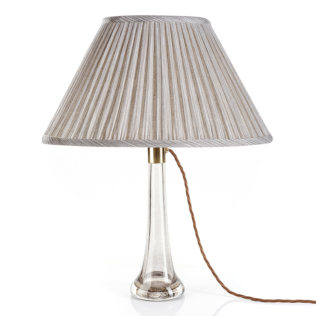 Fermoie Grey Strié oval lampshade styled on a glass table lamp in Nashville, Tennessee