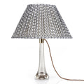 Fermoie Grey Wicker oval lampshade styled on a lucite table lamp in Nashville, Tennessee