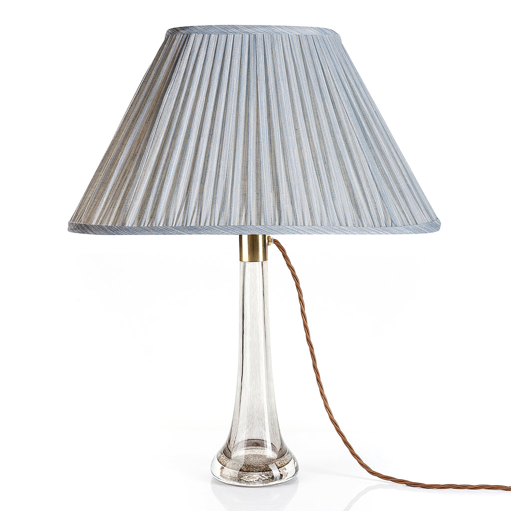Fermoie Light Blue Strié oval lampshade styled on a glass table lamp in Nashville, Tennessee