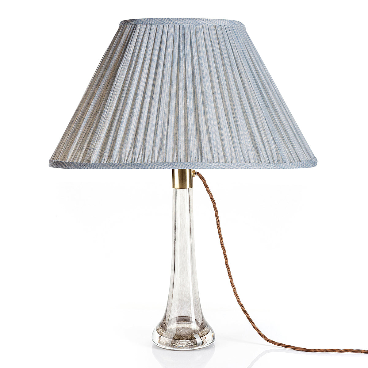 Fermoie Light Blue Strié oval lampshade styled on a glass table lamp in Nashville, Tennessee