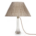 Fermoie Nut Brown Popple oval lampshade styled on a glass table lamp in Nashville, Tennessee