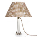 Fermoie Nut Brown Wicker oval lampshade styled on a glass table lamp in Nashville, Tennessee