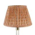 Fermoie Orange Popple empire lampshade styled on a glass table lamp in Nashville, Tennessee