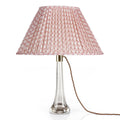 Fermoie Pink Wicker oval lampshade styled on a glass table lamp in Nashville, Tennessee