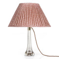 Fermoie Red Marden Oval lampshade styled on a glass table lamp in Nashville, Tennessee