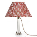 Fermoie Red Wicker Oval lampshade styled on a glass table lamp in Nashville, Tennessee