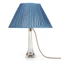 Fermoie Sacre Bleu oval lampshade styled on a glass table lamp in Nashville, Tennessee