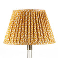Fermoie Yellow Rabanna empire lampshade styled on a glass table lamp in Nashville, Tennessee
