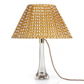 Fermoie Yellow Wicker oval lampshade styled on a glass table lamp in Nashville, Tennessee