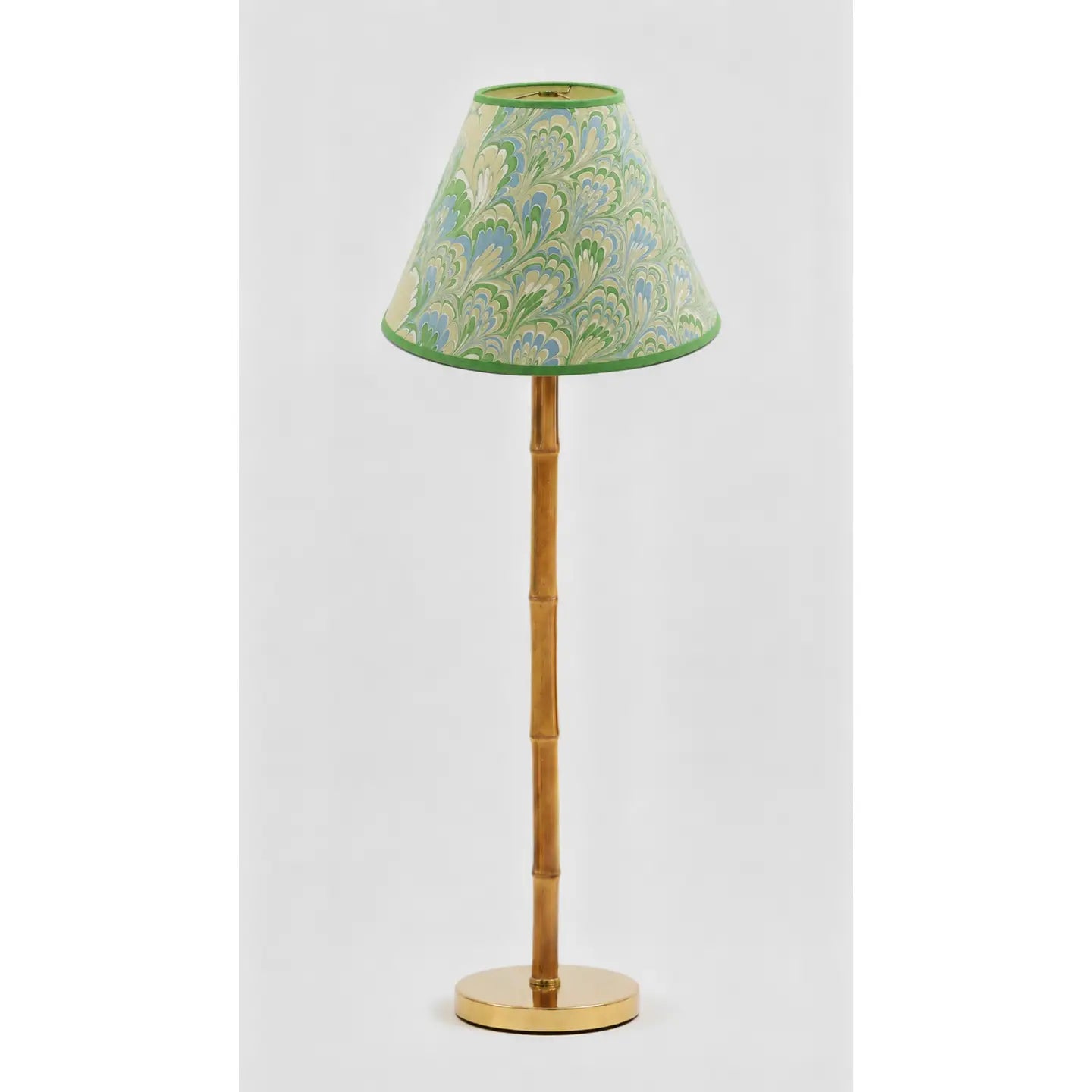 Green and blue marbled empire lampshade styled on a wood buffet lamp