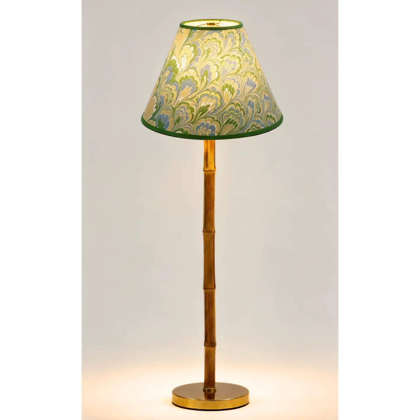 Green and blue marbled empire lampshade styled on a wood buffet lamp