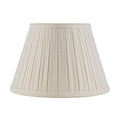 Eggshell linen lampshade with tailored box pleats, matching fabric trim, and a classic tapered empire silhouette.