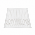 Bone linen lampshade with vertical pleating and intricate bottom smocked detailing in a tapered empire silhouette.