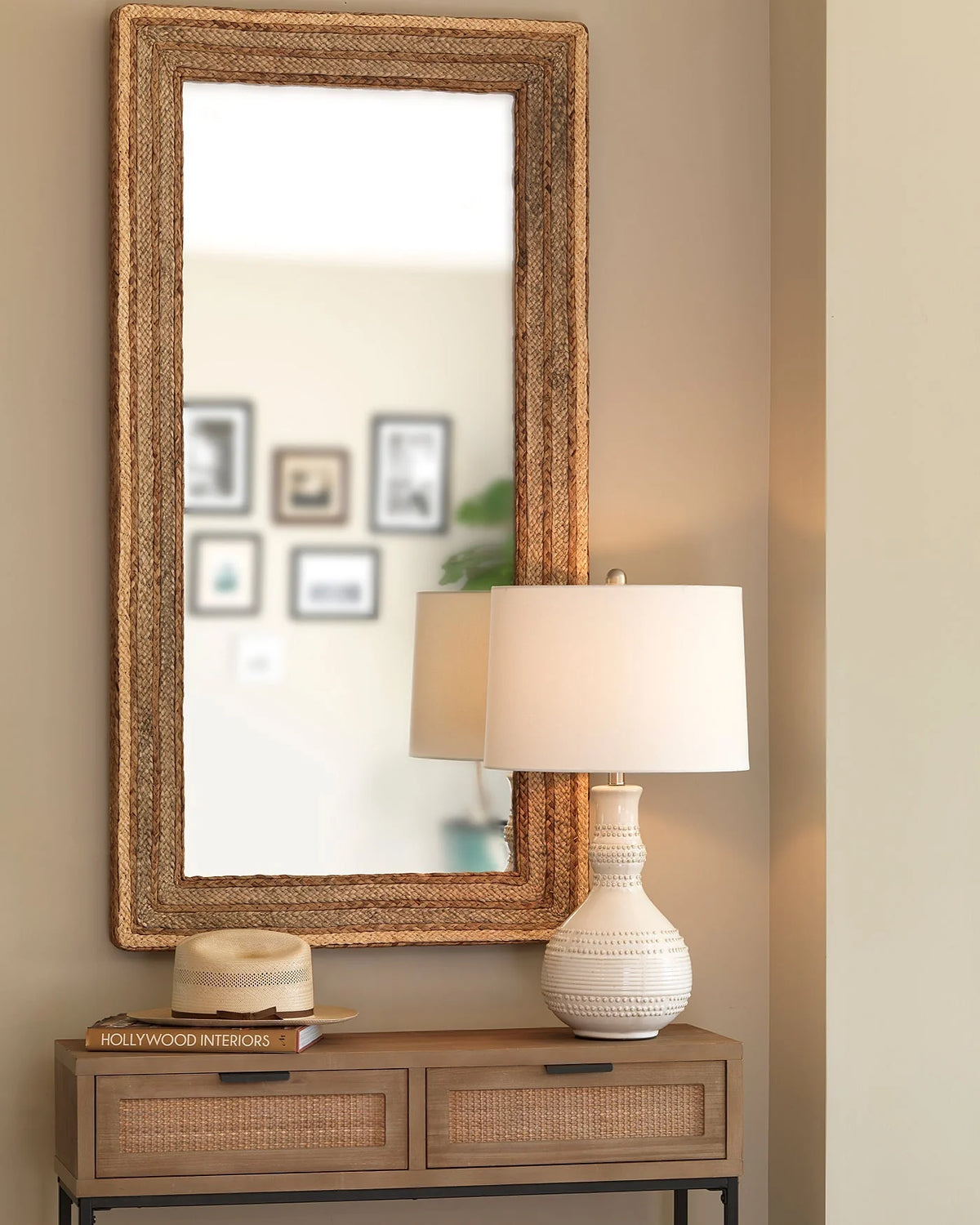 Organic ceramic white table lamp with raised knob texture and sculptural profile styled in a neutral entryway with natural fiber textured accents.