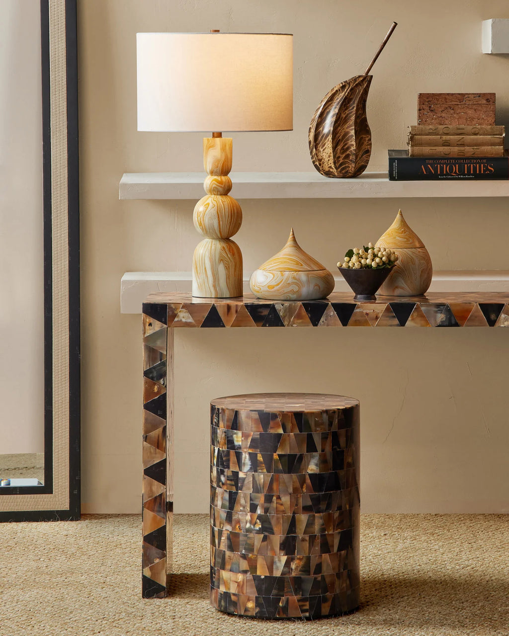 Yellow and white marbled contemporary table lamp with a white drum lampshade styled in a living room