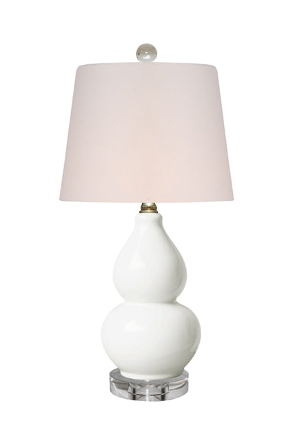 Mini white gourd table lamp with acrylic base and finial.