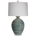 Blue artisinal pottery table lamp with a white drum lampshade