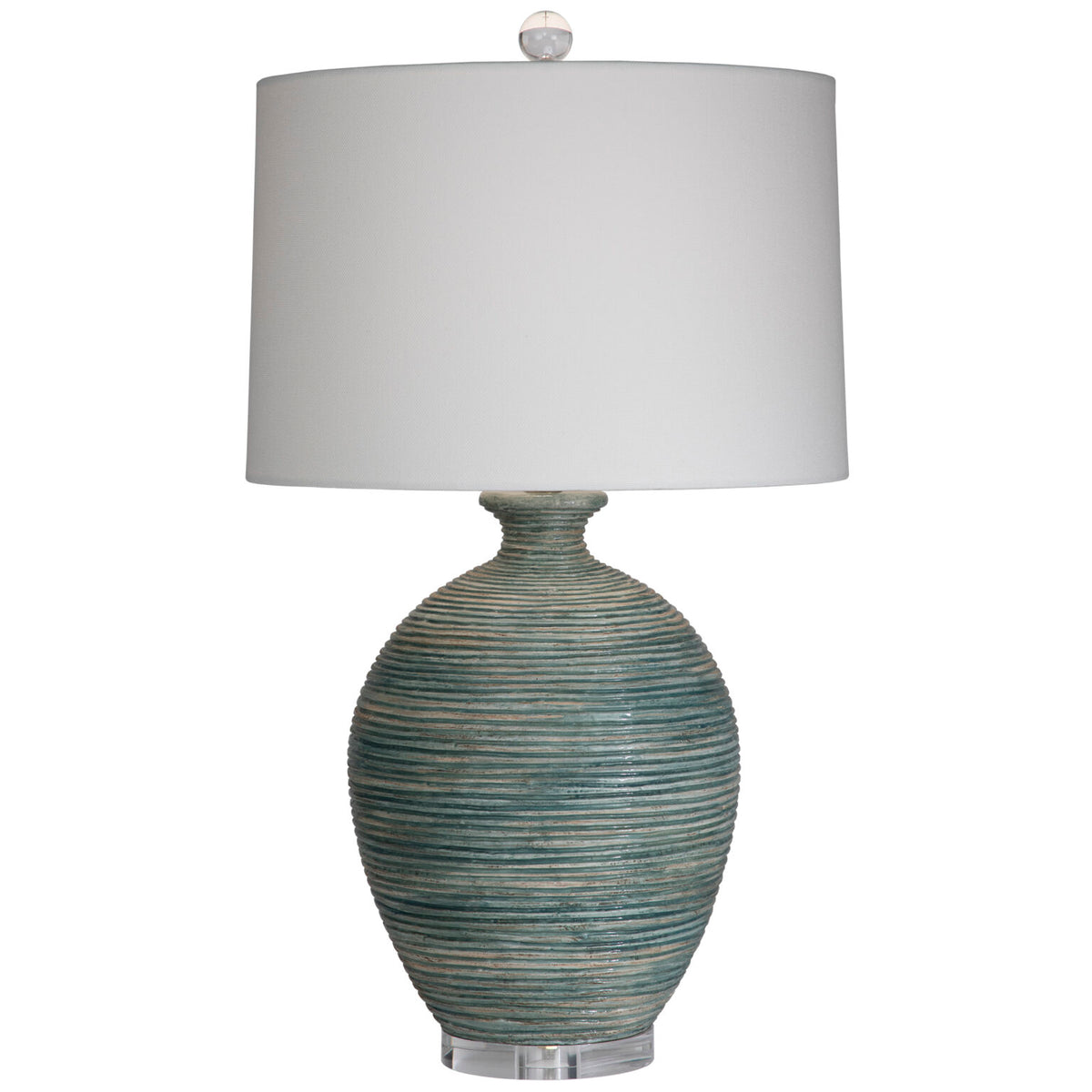 Blue artisinal pottery table lamp with a white drum lampshade
