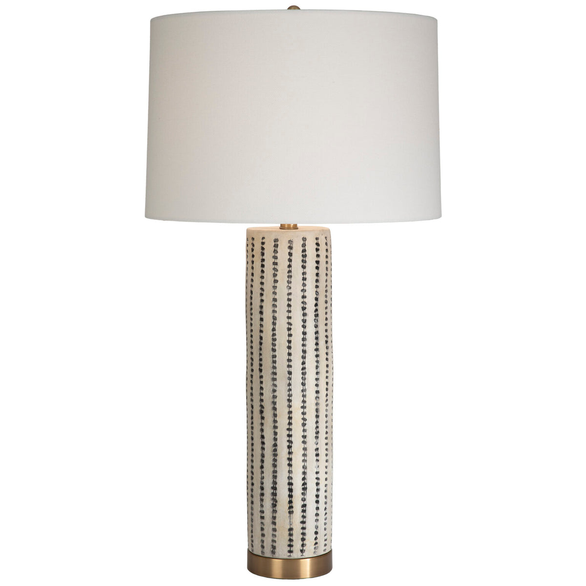 Tall, neutral, ceramic table lamp with a brass base and linen drum