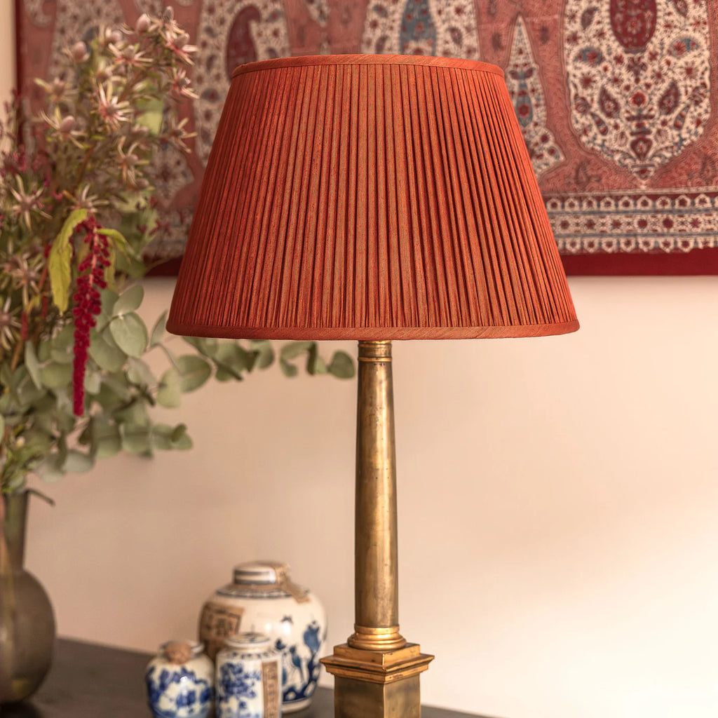 Nushka Red Coral Mulberry Silk lampshade styled on a brass table lamp in Nashville, Tennessee