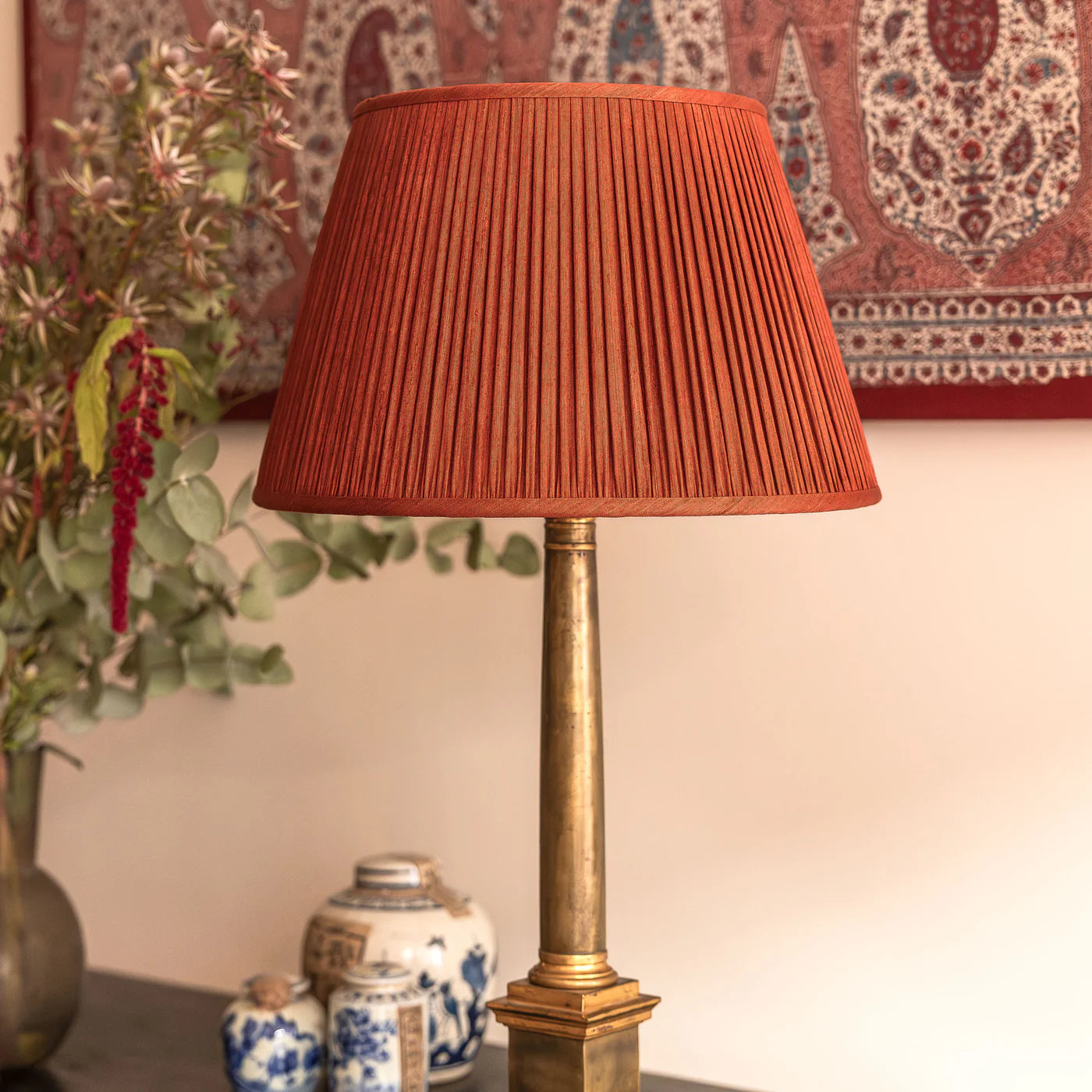 Nushka Red Coral Mulberry Silk lampshade styled on a brass table lamp in Nashville, Tennessee