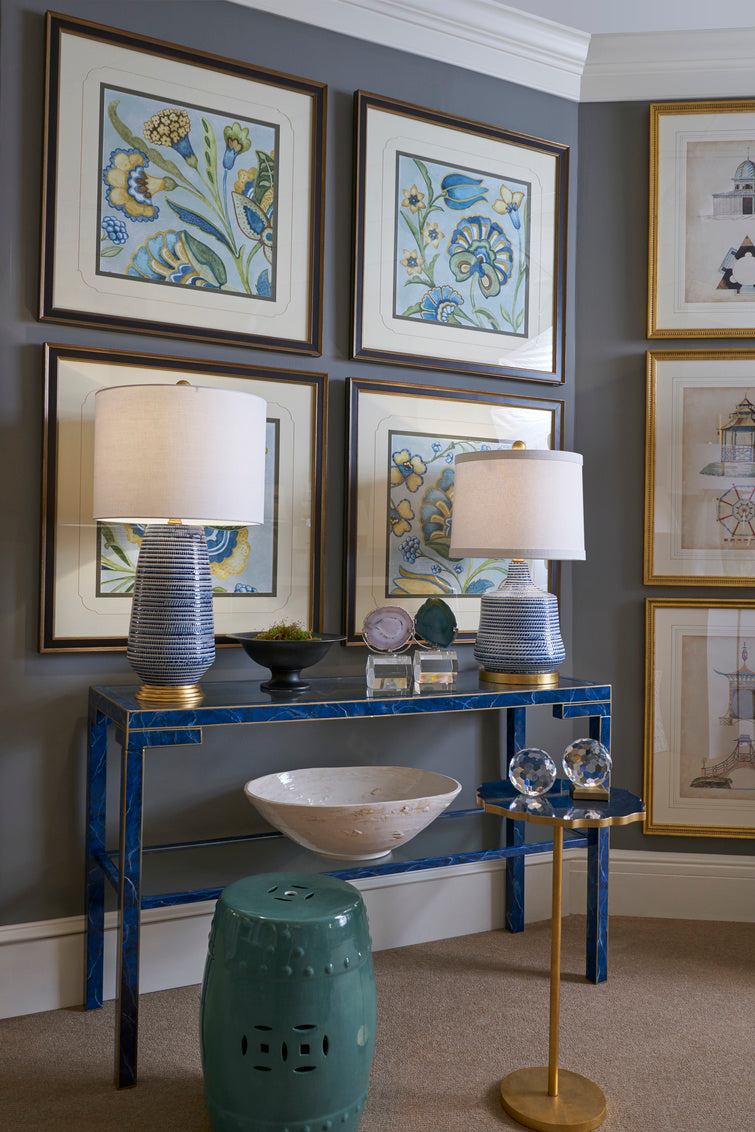 Blue and white table lamp with a white drum lampshade styeld in a living room in Nashville, Tennessee