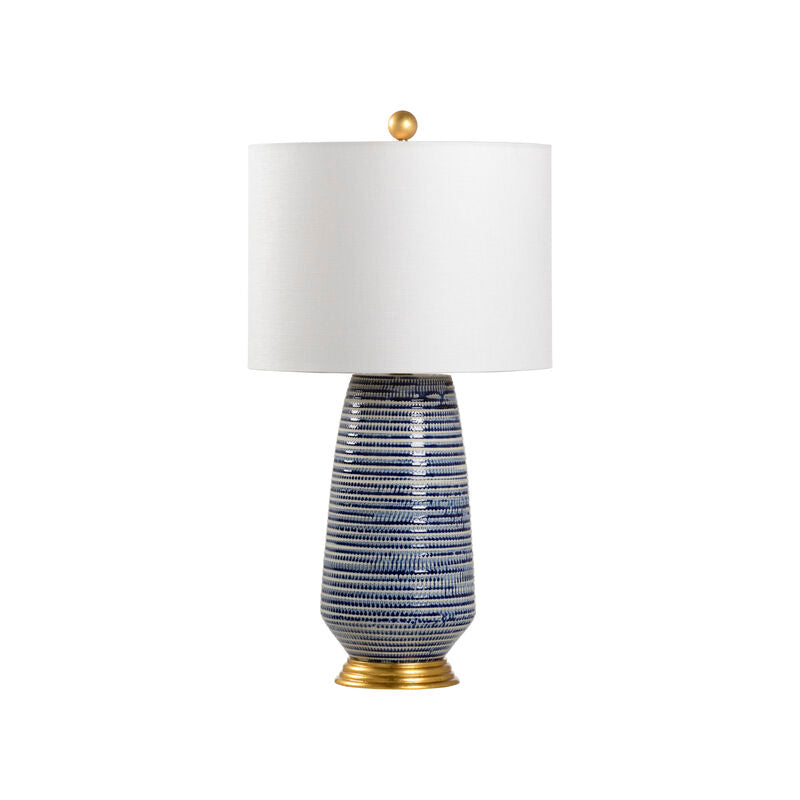 Blue and white ceramic table lamp with gold base and finial and white drum lampshade
