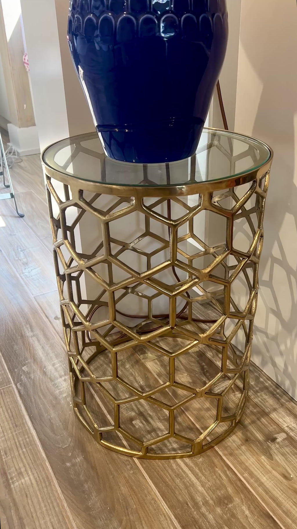 Contemporary brass and glass accent table with geometric honeycomb pattern, styled in Nashville, Tennessee