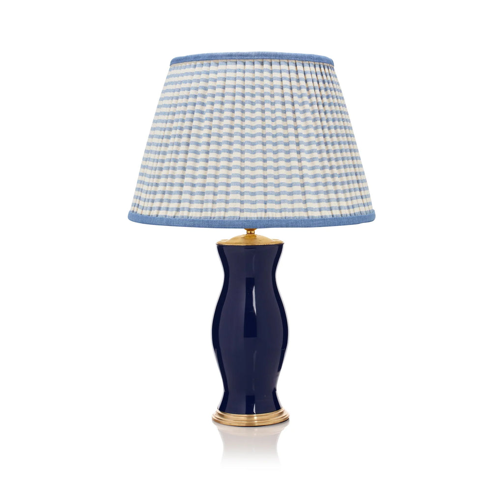 Rosanna Lonsdale Blue Striped Empire Lampshade styled on a navy blue table lamp in Nashville, Tennessee